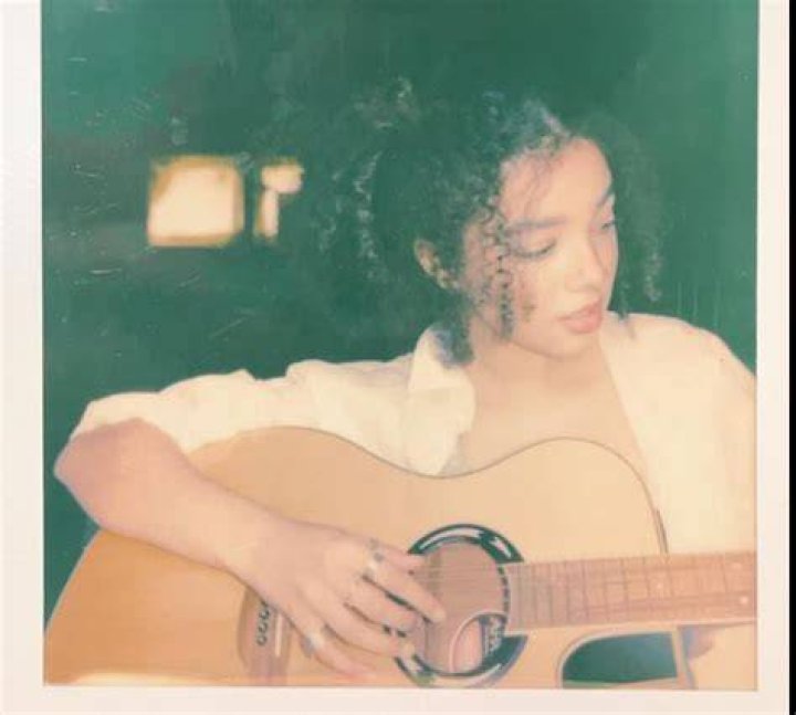 Malia Baker playing guitar